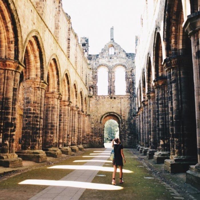 Embry-Riddle student walks through Kirkstall Abbey, a ruined Cistercian monastery in West Yorkshire, England.